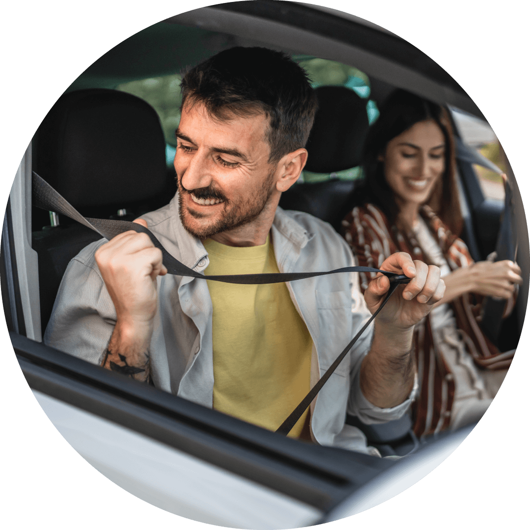Couple buckling seat belts after buying car with a traditional auto loan