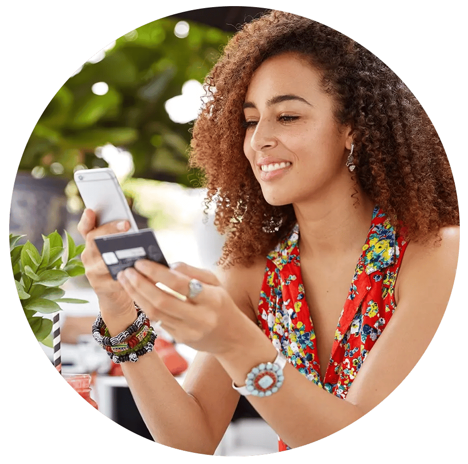 Woman holding phone and card in hand